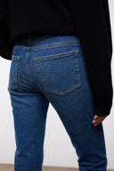 Women's stone blue stretch flare jeans, back pocket and waistband detail, cuffed hem