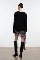SEPHIE skirt back view in speckled black-and-cream print with long side drape