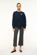 Navy cashmere crewneck sweater with embroidered insect emblem at chest