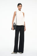 Black Maude mini carryall bag on model, compact profile with short top handles