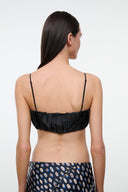 Back view: black silk bandeau top with thin straps and gathered ruffle back