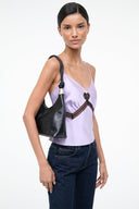 Black cuff shoulder bag worn on shoulder, braided trim and gold-tone hardware