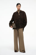 Dark brown suede button-up shirt, pointed collar, front buttons, flap pockets, long sleeves.