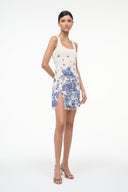 Womens sleeveless blue toile shift dress, white base, fitted waist, front slit, tassel hem