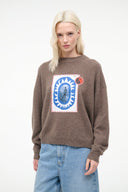 Relaxed crewneck cashmere sweater with blue oval-and-circle graphic patch on chest