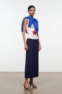 Floral black mule shoes with low kitten heel, worn with a navy pleated skirt