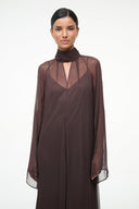Brown maxi dress with high neck scarf, sheer sleeves, and V-neck chest