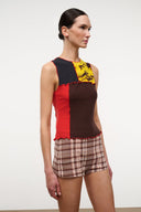 Sleeveless Primo top with yellow floral yoke, dark brown center, red side panel and ruffled hem