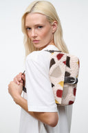 Patchwork suede crossbody bag with top handle and patterned front panel