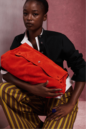 Oversized orange-red crossbody bag with zip closure and shoulder strap