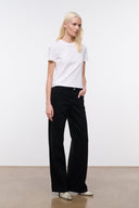 Black relaxed jeans with wide leg, button-and-zip front, belt loops, and pockets