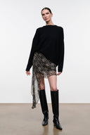 SEPHIE short skirt with speckled black-and-cream print, asymmetrical hem and side drape