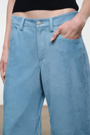 Sky blue suede pants with button closure, belt loops, and front slash pockets.