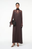 Brown maxi dress with high neck, sheer long sleeves, and V-neck front