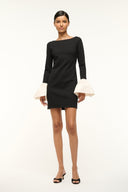 Black long-sleeve mini dress with ivory ruffled cuffs and straight hem