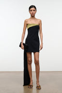Black satin clutch bag with olive-toned front panel, held in hand