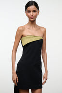 Strapless black mini dress with olive-gold curved bust panel and diagonal seam
