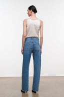 Medium-wash boyfriend jeans with wide legs, belt loops, and back yoke