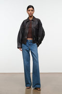 Distressed brown leather zip-up jacket with pointed collar and flap chest pockets