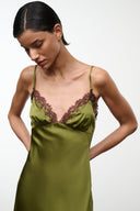Pear green silk slip dress close-up: brown lace V-neck and thin spaghetti straps