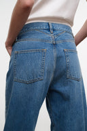 Medium-wash boyfriend jeans with back patch pockets and seam details