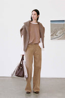 Beige knit cardigan with wide-leg tan trousers, long sleeves and open front