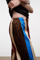 Silk striped pants close-up with elastic waist and blue side panel