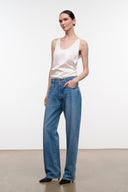 Medium-wash boyfriend jeans with wide legs, button waist, and five pockets