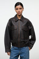 Distressed brown leather zip jacket with stitched flap pockets and elastic cuffs