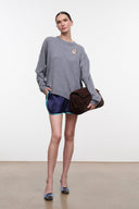 Ash gray cashmere crewneck sweater with embroidered dog crest; relaxed fit