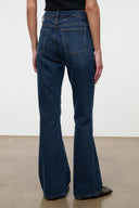 Medium-wash flare jeans with front button fly and two front pockets