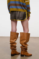 Dark gray shorts with yellow piping, elastic waistband, side tie detail