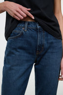 Dark blue flare jeans with contrast topstitching, patch pockets, button fly