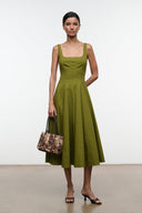 Wells dress, olive green sleeveless midi A-line with square neckline; holding handbag