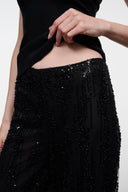 Black sequin pants with elastic waistband, close-up side view