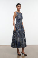 Sleeveless navy midi dress with allover yellow-dot abstract print and flared skirt