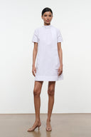 White mini dress with high neck and short sleeves, straight hem.