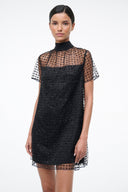 Mini shift dress with mock neck, dark onyx sparkly body, sheer short sleeves with star print.