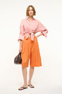 Faded blush linen button-up top with pointed collar and tied waist front
