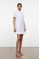 White mini dress, side view, high collar and short sleeves.