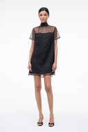 Mini shift dress with mock neck, dark onyx sparkly fabric, sheer star-pattern sleeves.