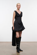 Black silk mini dress on model, V-neck corset bodice with gathered bubble skirt