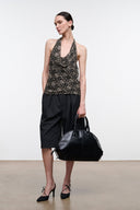 Speckled halter top with open-back ties and layered drape hem