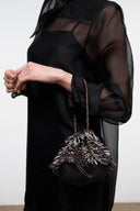 Black multi beaded mini crossbody bag with chain strap and pom-pom top