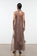 Taupe maxi dress with open back, neck tie, and feather applique accents