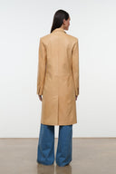Tan leather long coat, back view with tailored seam lines and cuff detailing.