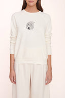 Cream sweatshirt with small circular chest graphic, crewneck and ribbed cuffs