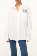 Oversized white button-up shirt with cat patch and chest pocket, long sleeves