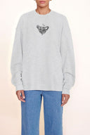Grey oversized sweatshirt with black animal graphic logo at the chest