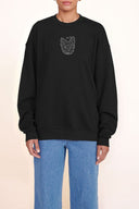 Black oversized crewneck sweatshirt with embroidered cat face at chest